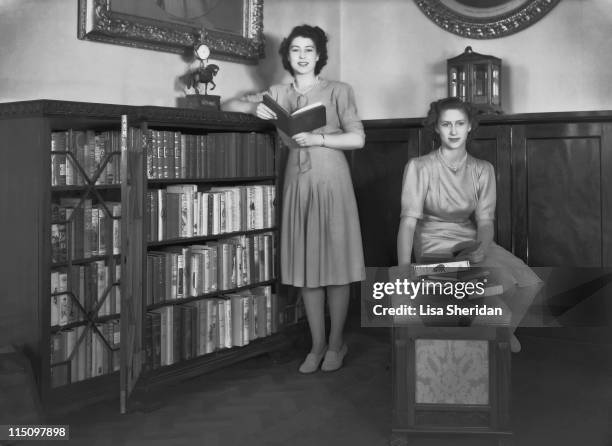 Princess Elizabeth and her sister Princess Margaret in a library in Buckingham Palace on July 19, 1946.