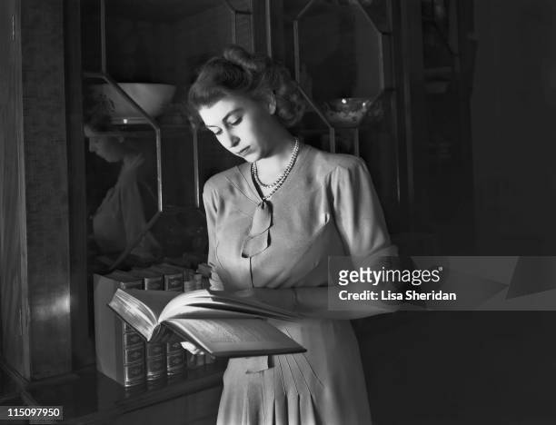 Princess Elizabeth reading a book in Buckingham Palace on July 19, 1946.