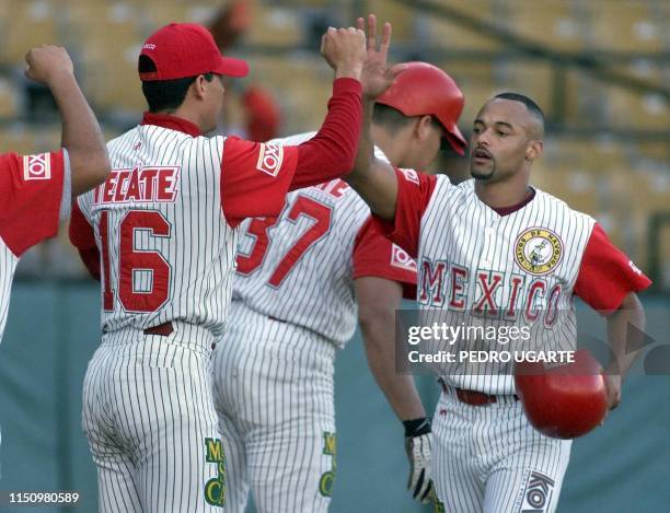 Mexican player, Darrel Sherman greets his teammates after another run in the third inning of the game between Mexico and Venezueela 07 February, 2000...