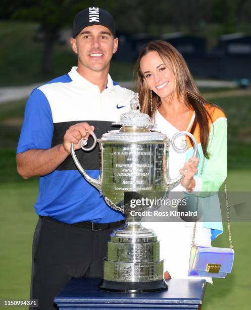 Brooks Koepka of the United States poses with girlfriend Jena Sims and the Wanamaker Trophy during the Trophy Presentation Ceremony after winning the...