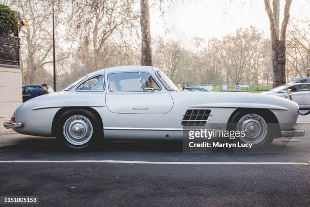 The Mercedes-Benz 300 SL outside the Dorchester Hotel in London, England. The 300 SL was produced from 1954 to 1963. First as a coupe from 1954 to...
