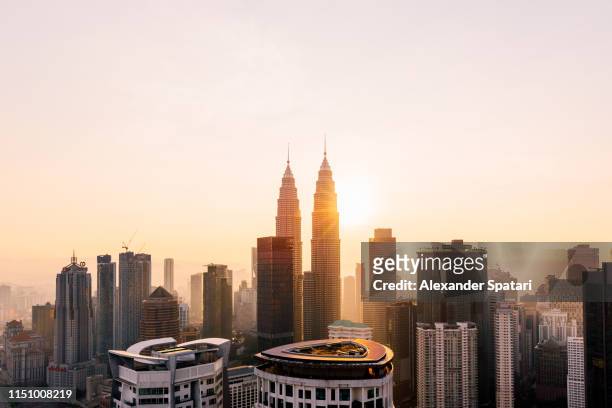 petronas towers and kuala lumpur skyline at sunrise, malaysia - kuala lumpur stock pictures, royalty-free photos & images