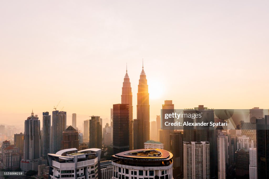 Petronas Towers and Kuala Lumpur skyline at sunrise, Malaysia