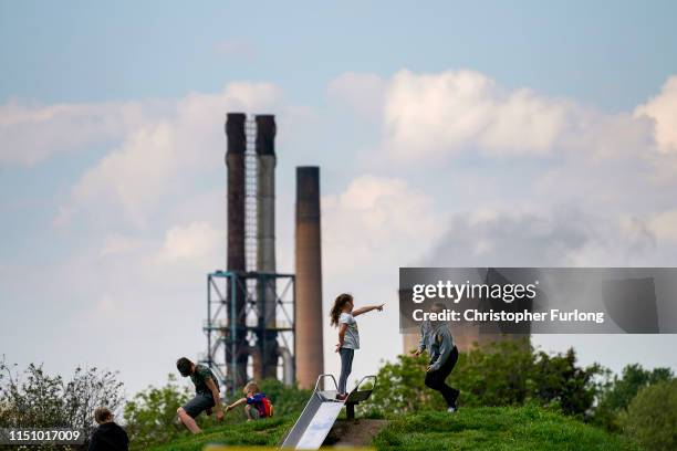 Children play in park against the backdrop of British Steel's Scunthorpe works which has been forced into liquidation today on May 22, 2019 in...