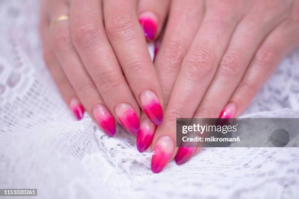 close-up of woman fingers with nail art manicure with pink colour - ombré imagens e fotografias de stock