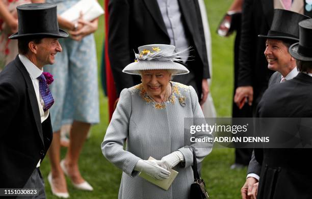 Britain's Queen Elizabeth II talks with CEO of Ascot, Johnny Weatherby and her racing adviser John Warren on day three of the Royal Ascot horse...