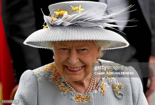Britain's Queen Elizabeth II smiles as she attends day three of the Royal Ascot horse racing meet, in Ascot, west of London, on June 20, 2019. The...