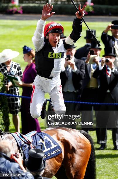 Jockey Frankie Dettori jumps from his horse Star Catcher after winning his third race, the Ribblesdale Stakes, his 65th Ascot win, on day three of...