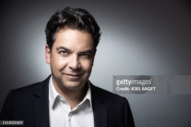 French journalist Patrick Cohen poses during a photo session in Paris on June 19, 2019. - "C a vous" TV show, hosted by French TV host Anne-Elisabeth...