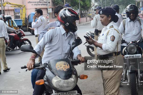 Pune traffic police issuing an E-Gift coupon under Abhar Yojana to followers of traffic rules, checking their history on E chalan machine, those who...