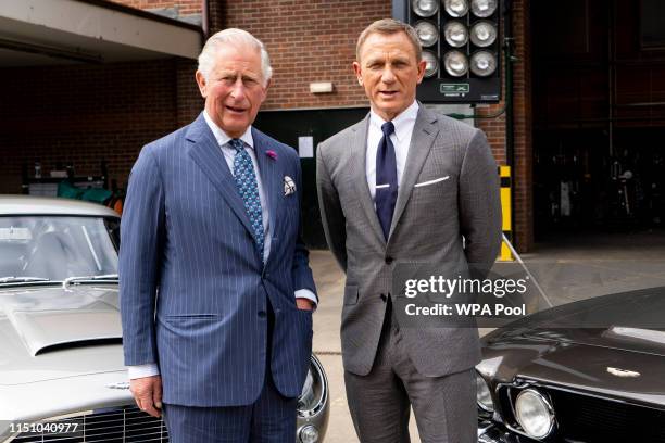 Prince Charles, Prince of Wales poses with British actor Daniel Craig as he tours the set of the 25th James Bond Film at Pinewood Studios on June 20,...