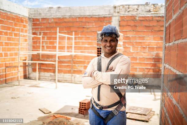 construction worker standing in a construction site - single brick stock pictures, royalty-free photos & images