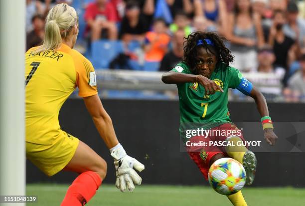 Cameroon's forward Gabrielle Onguene kicks to the goal as New Zealand's goalkeeper Erin Nayler goes to block it during the France 2019 Women's World...