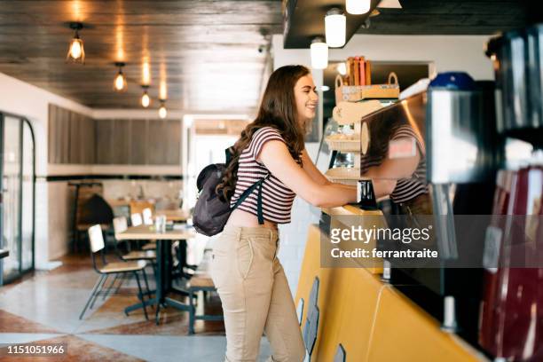Millennial woman at ordering Coffee shop counter