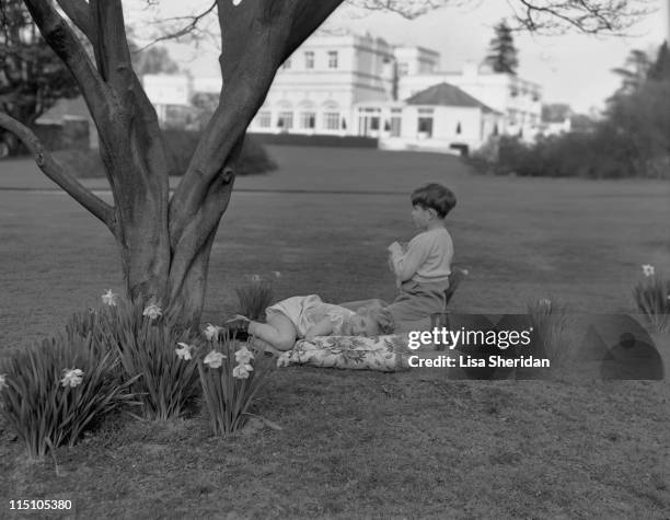 Princess Anne and Prince Charles playing in the garden of the Royal Lodge in Windsor, England on April 07, 1954.