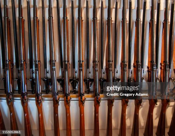 old rifles and swords in a rack ready for use - ironclad stock pictures, royalty-free photos & images