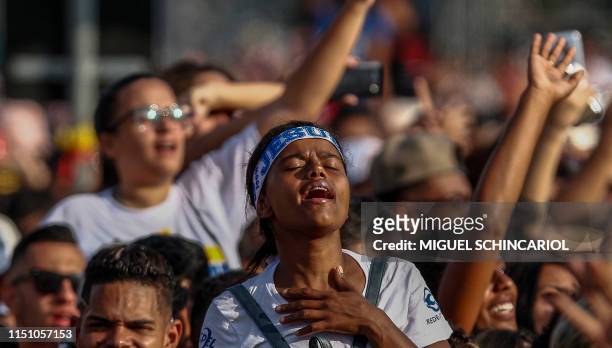 Woman attends the 27th edition of the "March for Jesus" to celebrate Corpus Christi, an event that gathers a wide range of evangelical congregations,...