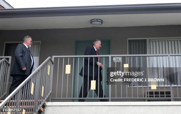 Detectives Tom Small and Mark Lillienfeld walk past apartment where Michael Gargiulo stayed during a jury site visit to the scene of the crime in El...