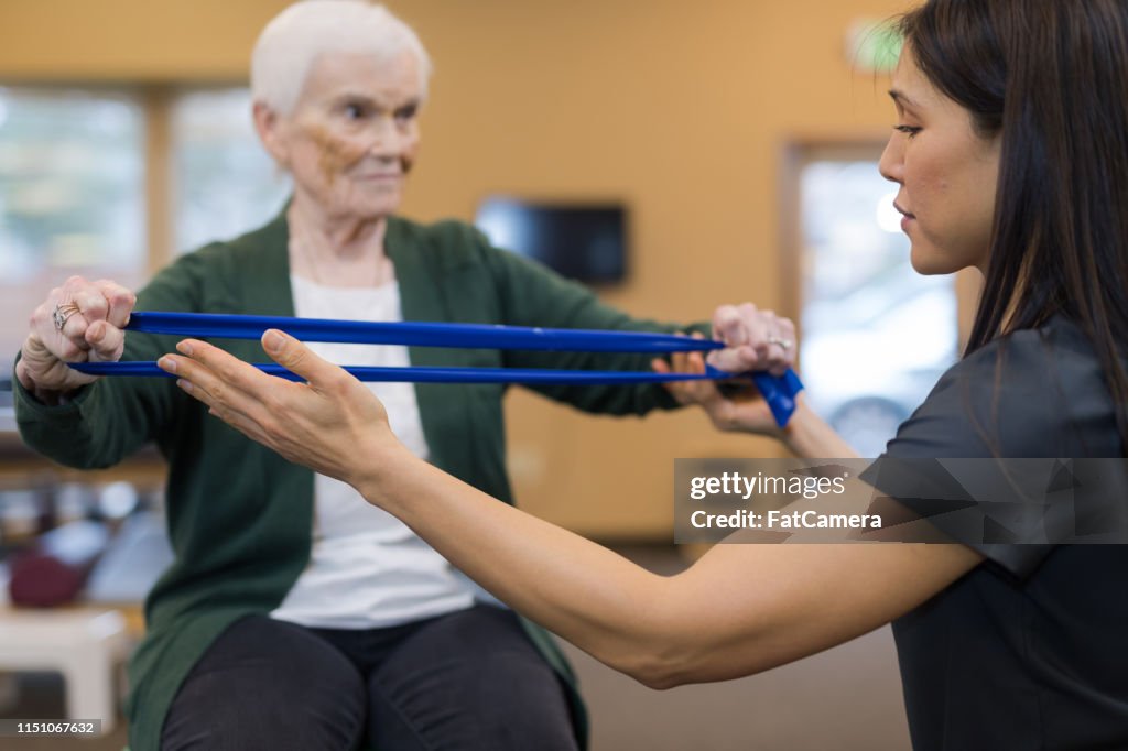 A Senior Woman Works With Her Occupational Therapist High Res Stock a-senior-woman-works-with-her-occupational-therapist-high-res-stock