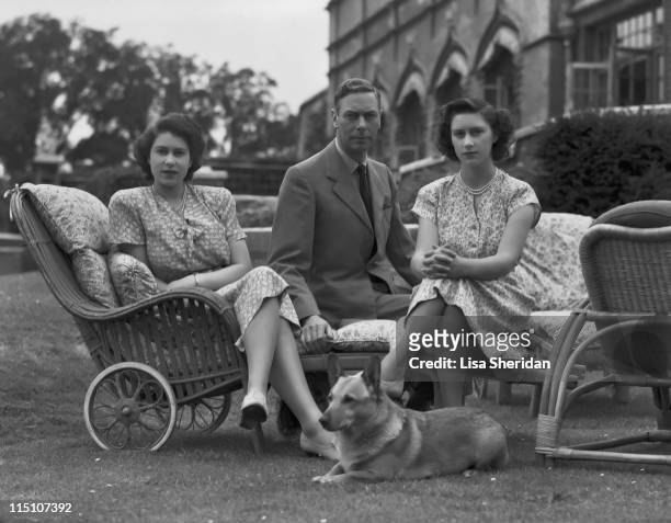 King George VI with his daughters Princess Elizabeth and Princess Margaret in the grounds of Windsor Castle in Windsor, England, 8th July 1946.