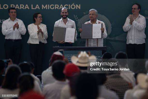 Mexico President Manuel Lopez Obrador and El Salvador President Nayib Bukele display a document of agreement during a joint press conference...