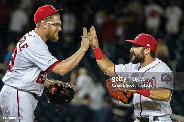 Sean Doolittle of the Washington Nationals celebrates with Anthony Rendon after the game against the Philadelphia Phillies at Nationals Park on June...
