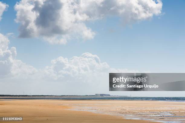 beach flecha del rompido with city of huelva on background - huelva province stock pictures, royalty-free photos & images