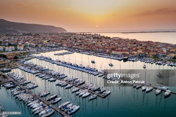 sailboats in the marina and the city of lefkada island, greece - lefkada city stock-fotos und bilder