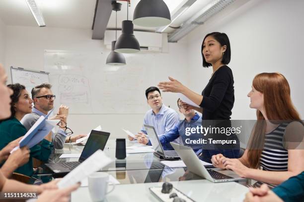 colleague making a presentation speech. board room meeting in a berlin office. - proposition stock pictures, royalty-free photos & images