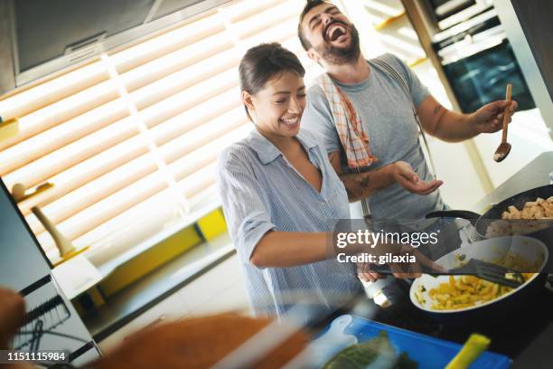 young couple cooking at home. - stir frying european stock pictures, royalty-free photos & images