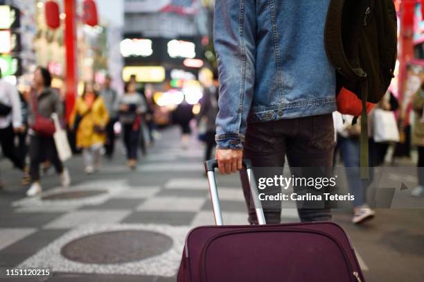 man with suitcase in busy shopping district - passenger point of view bildbanksfoton och bilder