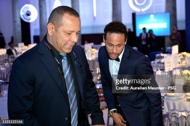 Neymar Jr and his father Neymar Santos Sr look for their table during the PSG Foundation gala diner on May 22, 2019 in Paris, France.
