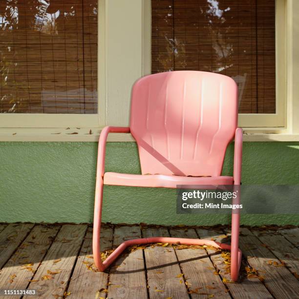 pink metal chair on a porch - front porch no people stock pictures, royalty-free photos & images