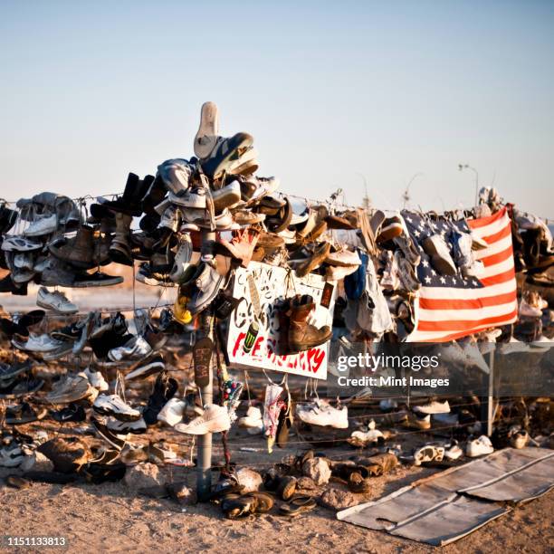 shoes hanging on fence - climate protest stock pictures, royalty-free photos & images