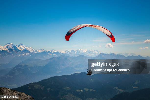 paragliding over the swiss alps - interlaken ストックフォトと画像