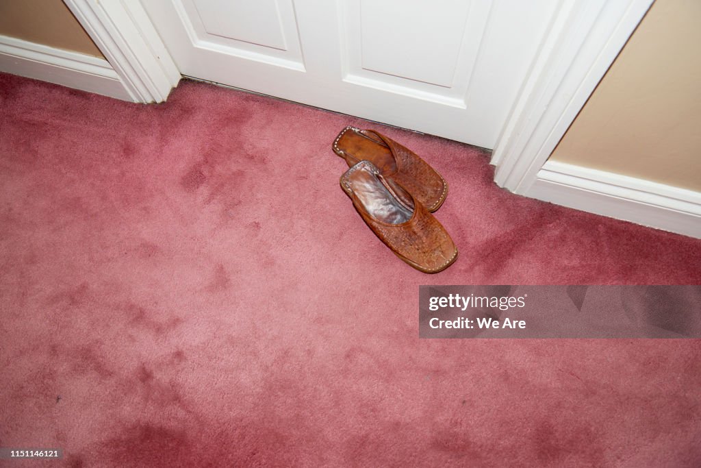 Leather slippers outside bedroom door
