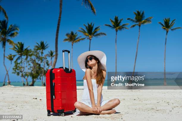 girl tourist in a white dress by the ocean with a suitcase - pink dress stock pictures, royalty-free photos & images