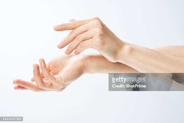 female hands on a white isolated background - showing skin stock pictures, royalty-free photos & images