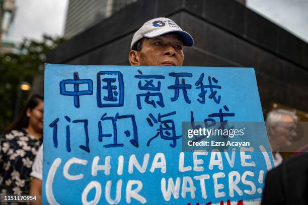 Filipinos take part in a protest condemning China's incursion at the West Philippine Sea, on June 21, 2019 in Makati, Metro Manila, Philippines....