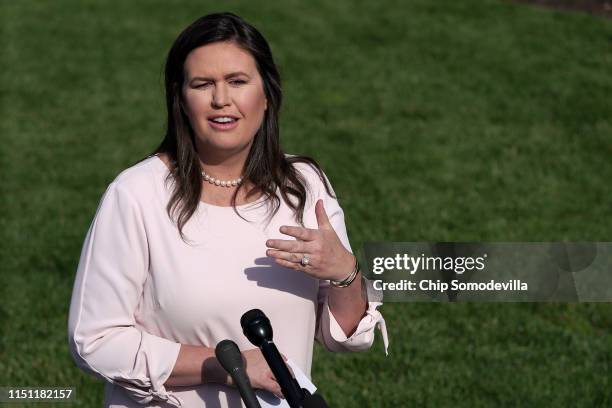 White House Press Secretary Sarah Huckabee Sanders talks to reporters after an interview with FOX News outside the West Wing May 23, 2019 in...