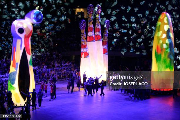 Participants parade arround three of the representations of famous monuments in Barcelona, the woman and bird by Joan Miro , The Sagrada Familia by...