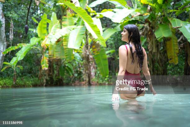 woman exploring the fervedouro in tocantins, brazil - tocantins stock pictures, royalty-free photos & images