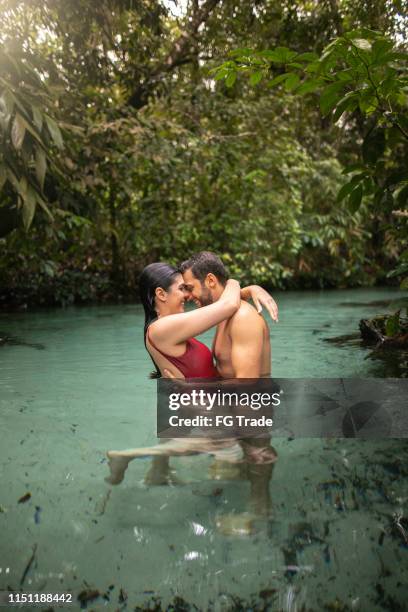 couple embracing in waterfall in tocantins, brazil - tocantins stock pictures, royalty-free photos & images