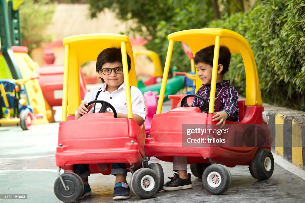 Children Enjoying Toy Car Ride High-Res Stock Photo - Getty Images