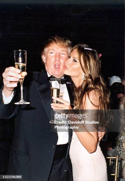 American real estate developer Donald Trump and his girlfriend, model Melania Knauss , raise their glasses for a New Year's toast at the Mar-a-Lago...