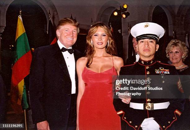 Portrait of married couple, American real estate developer Donald Trump and model Melania Trump, along with a US Marine color guard at the Red Cross...