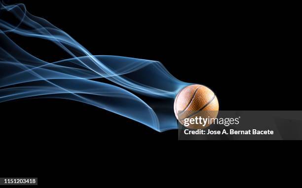 fall of a very fast basketball ball with a trail of white smoke on a black background. - valencia basket photos et images de collection