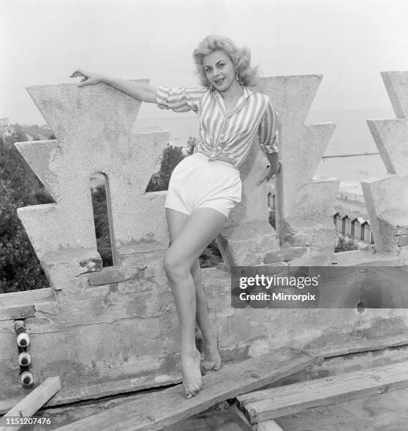 Venice Film Festival, Friday 31st August 1956; pictured is Italian actress Sandra Milo, wearing striped shirt and white shorts.