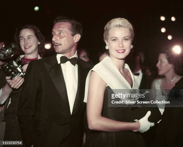 American actress Grace Kelly attends the premiere of the film 'Rear Window' with fashion designer Oleg Cassini , 1954.
