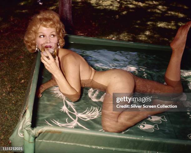 Danish actress Greta Thyssen in a paddling pool, circa 1955.
